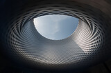 Fototapeta Miasto - Messe Basel: Unveiling the Intricate Beauty of an Architectural Marvel, where Circular Patterns and Aluminum Panels Weave a Mesmerizing Tapestry around a Central Void