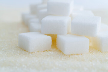 Wall Mural - Sugar cubes on top of granulated sugar