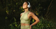 © Jacob Lund - Woman listening to music and doing a breathing exercise outdoors
