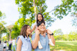 © CandyRetriever  - Happy Asian family spending time together travel on summer holiday vacation. Parent and little child enjoy and fun outdoor activity lifestyle walking and playing together at public park in the city.