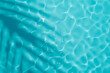Aqua waves and coconut palm shadow on blue background. Water pool texture top view.Tropical summer mockup design. Luxury travel holiday.