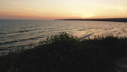 Wall Mural - Coast in Sicily after a hot summer sunset and log waves of sea