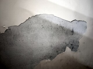 Dark Plaster Wall With Dirty Scratched Background.Oldwall With Peel Grey Stucco Texture.Retro Vintage Worn Wall Wallpaper.Decayed Cracked Rough Wall.old painted gray peeling cracked damp spotted wall 