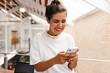 © (JLco) Julia Amaral - Happy young businesswoman reading a text message on her smartphone