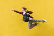 © Богдан Маліцький - young guy student with backpack flies forward and hurries to study, man jumps and runs in the air