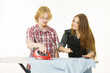 © Voyagerix - Woman teaching men how to do ironing