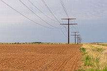 High Power Line Supported By A Row Of Towers Through A Plowed Field, Quitaque, Texas