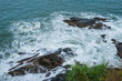 Sea waves hitting rocks, top view