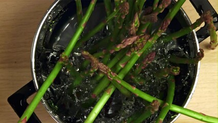 Sticker - The asparagus falls into the pot. Filmed is slow motion 1000 fps. High quality FullHD footage