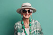 © ADDICTIVE STOCK - Generative AI illustration of portrait of glad retired woman wearing colorful casual clothes and hat in sunglasses smiling green background