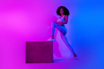 Poster - Full body photo pilates trainer woman stretching platform box advertise her new sportswear isolated over blue pink neon filter background