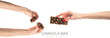 Healthy granola bar (muesli or cereal bar) isolated on white background. Muesli bar in females hands with red manicure.