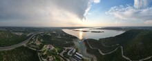 Aerial View Of Lake Travis And The Texas Hill Country During A Passing Thunderstorm At Sunset.