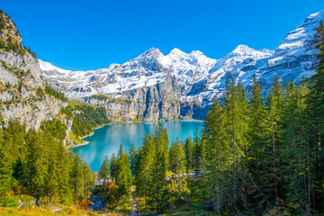 Wall Mural - Amazing tourquise Oeschinnensee with waterfalls and Swiss Alps, Kandersteg, Berner Oberland, Switzerland.