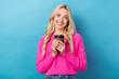 © deagreez - Portrait of optimistic cute girlish woman with curly hairstyle wear knit pullover hold cup of coffee isolated on blue color background