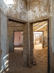 Architectural views of sand filled abandoned homes in diamond mining ghost town.