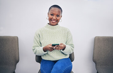 Poster - Black woman, phone and portrait on a chair in a waiting room with network connection for social media. African person happy for recruitment interview with a smartphone for internet, website or app