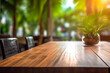 Close-up of Wooden Table in Summer Terrace Cafe  Restaurant or Coffee Shop. Blurred Bokeh Background. Product Display, Presentation. Palm Trees on Background. Selective Focus. Copy Space.