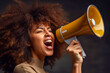 Happy beautiful young African American woman with afro hair wielding megaphone. Isolated on dark studio background. Self promotion of small business, advertising, SMM, PR, Marketing themes. 16:9