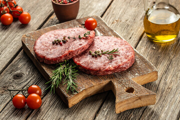 Poster - Fresh raw meat cutlets on a wooden background, banner, menu, recipe place for text, top view