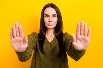 Wall Mural - Portrait of calm focused lady arms palms demonstrate stop enough symbol you isolated on yellow color background