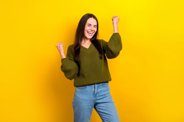 Sticker - Photo of adorable lucky woman dressed khaki sweater shouting rising fists isolated yellow color background