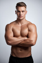 Portrait, Man And Bodybuilder With Arms Crossed On Studio Background, Backdrop And Topless Abs. Sexy, Serious And Strong Male Model, Sports Athlete And Fitness For Exercise, Confidence And Muscles