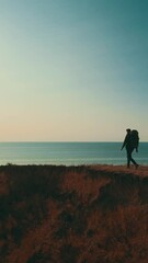 Wall Mural - the man with backpack walking on the mountain on beautiful seascape background