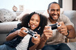 Leinwandbild Motiv Gaming, family or children with a father and daughter in the living room of their home playing a video game together. Kids, happy or fun with a gamer dad and girl child in the house to play online