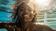 © annebel146 - Happy black woman swimming under water in public swimming pool,Holiday, relaxtion,active,watersport,beauty having fun