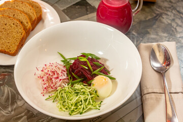 Wall Mural - Ingredients for cold beetroot soup with beetroot leaves, radishes, cucumber and buttermilk.