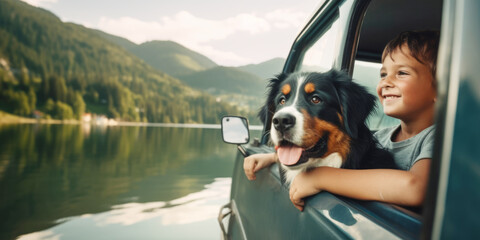 Portrait of cute bernese shepherd and little boy on the car window vacation travel