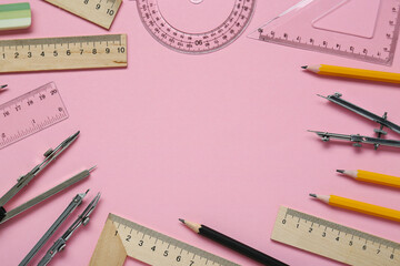 Wall Mural - Flat lay composition with different rulers and stationery on pink background. Space for text