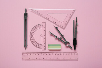 Wall Mural - Flat lay composition with different rulers and stationery on pink background