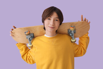 Wall Mural - Teenage boy with skateboard on lilac background