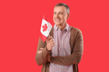 Poster - Mature man with flag of Canada on red background