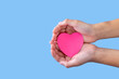 © Darunrat - Closeup,Child's hands with a red heart on blue background.Give love philanthropy,help warmth and take care,protect children's health,blood donation and stem cell,valentines day concept.Space for text.