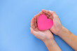 © Darunrat - Closeup,Child's hands with a red heart on blue background.Give love philanthropy,help warmth and take care,protect children's health,blood donation and stem cell,valentines day concept.Space for text.