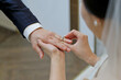 © Daewan - Photo of the bride putting the wedding ring on the groom's fourth finger