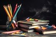 Close up of a blackboard with school supplies on a wooden desk