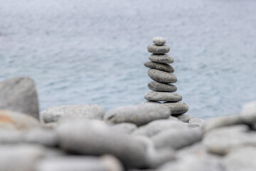 Canvas Print - Pebble tower balance harmony stones arrangement on sea beach coastline