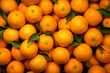 Background of fresh mandarins or oranges with green leaves. Generative AI