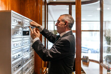 Concierge Opening The Mailboxes Of The Residents Of The Building