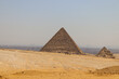 small pyramid of giza and ruins nearby on a sunny day