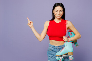 Wall Mural - Young latin woman she wear red casual clothes hold rollers point index finger indicate on workspace area copy space mock up isolated on plain pastel purple background Summer lifestyle leisure concept.