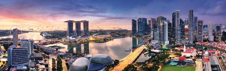 Wall Mural - Skyscrapers of Singapore skyline at the beautiful sunset, aerial panorama