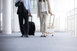 Businessmen and women with carry-on bags for easy use at train stations, airports, business trips, travel, etc. Images of overseas business trips and airports No face