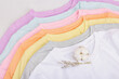 © FuzullHanum - Vertical storage of clothing. Eco spring closet cleaning. Pastel baby T-shirts, sale concept