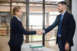© เลิศลักษณ์ ทิพชัย - Businessman or manager handshake with young businesswoman business partners shaking hands in the office concept of partnership