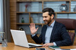 © Liubomir - Online meeting, mature businessman inside office talking remotely online with colleagues and partners, video call senior male executive using laptop to communicate